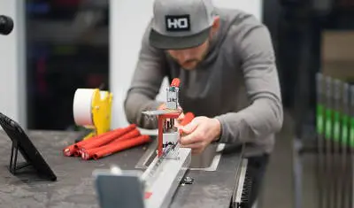 photo showing a workshop employee gripping a golf club in the workshop