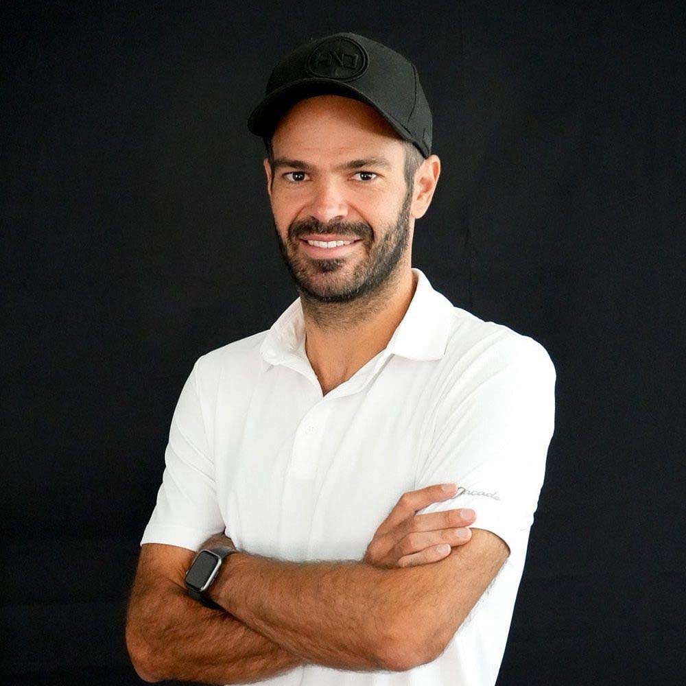 photo showing an HIO employee in a white polo and a black golf cap