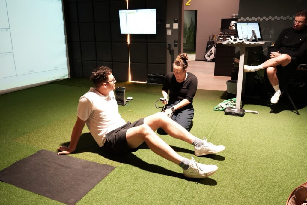 treating a male golfer inside of a golf fitting studio